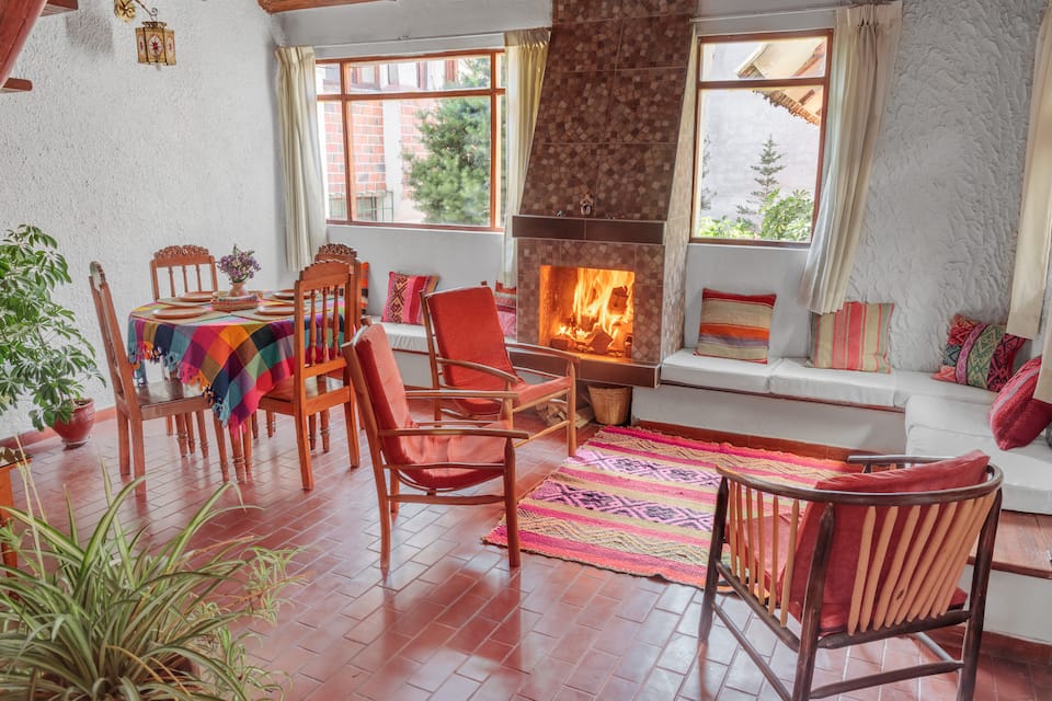 Ninnab cabin dining area and fireplace, shown in its Airbnb listing
