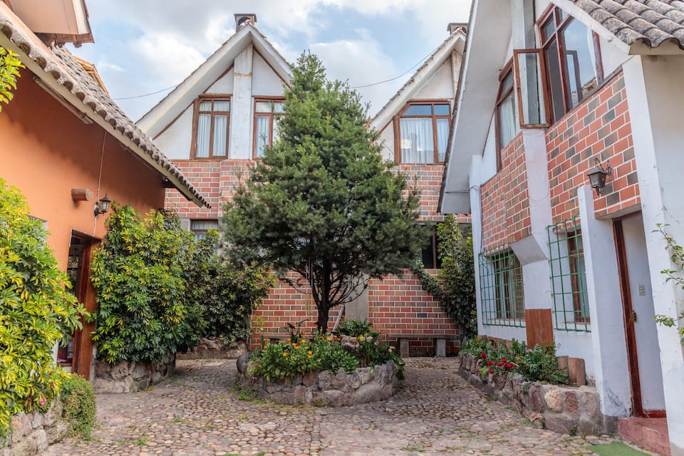 Ninnaf cabin exterior and planted courtyard, shown in its Airbnb listing