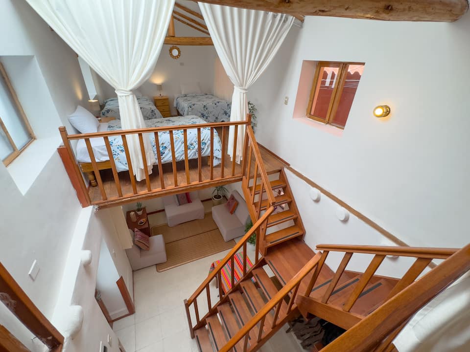 Paccaz duplex interior with timber stairs, shown in its Airbnb listing